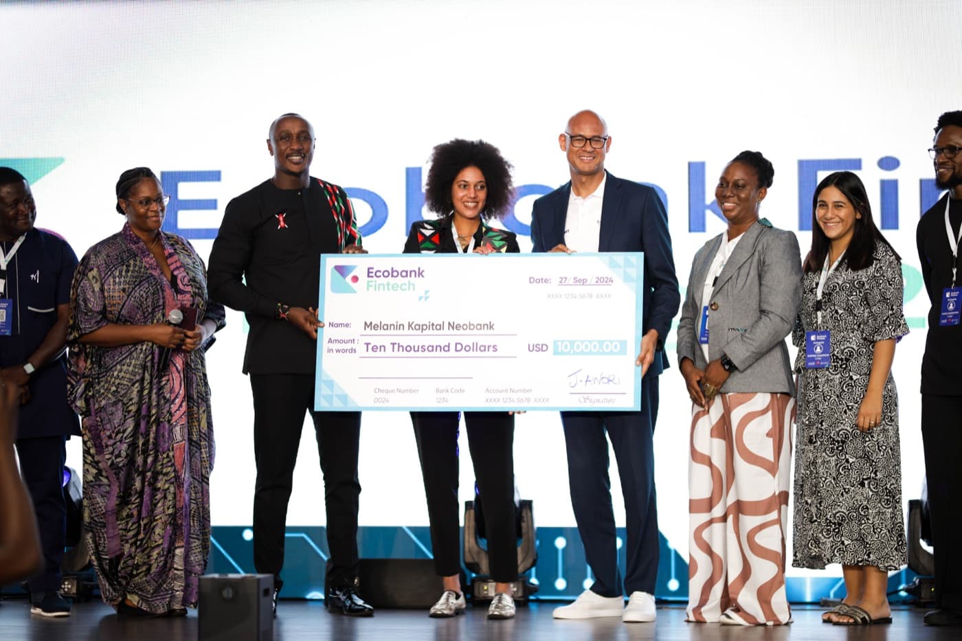 The team on stage at the Ecobank Fintech Challenge, holding the presentation cheque